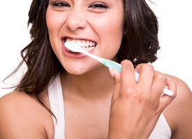 attractive woman brunette hair brushing teeth